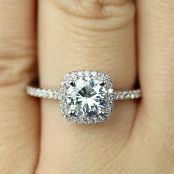 Geometric sculpted platinum alloy ring with diamond insert on white background