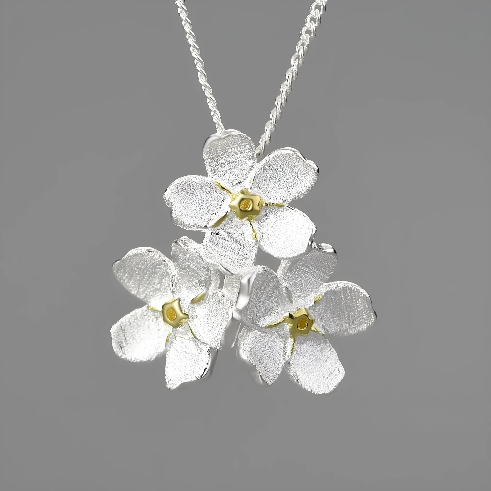 Myosotis Sylvatica sterling silver flower pendant with electroplated finish and hand-designed botanical details