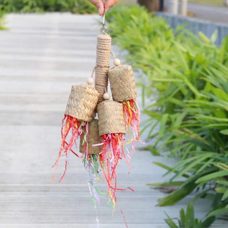 Colourful shredded paper parrot toy with wood and sisal construction measuring 15 by 35 centimetres