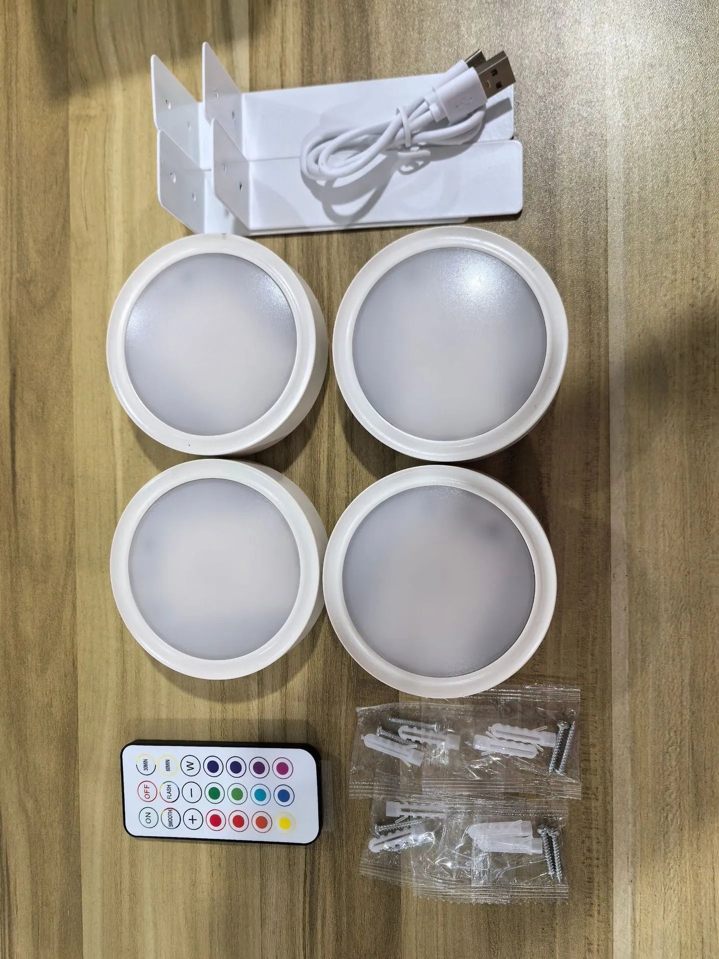 Wireless LED painting lamp with a magnetic mounting belt and remote control in black finish.
