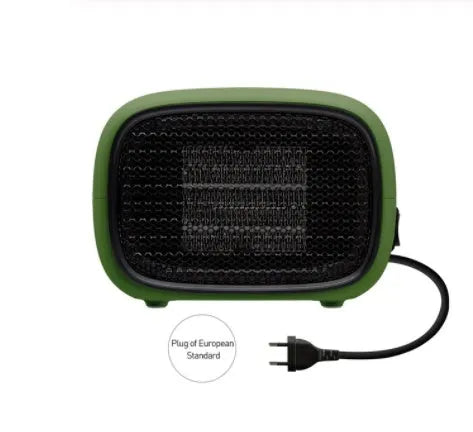 Compact green mini ceramic heater with metal mesh front on a wooden desk