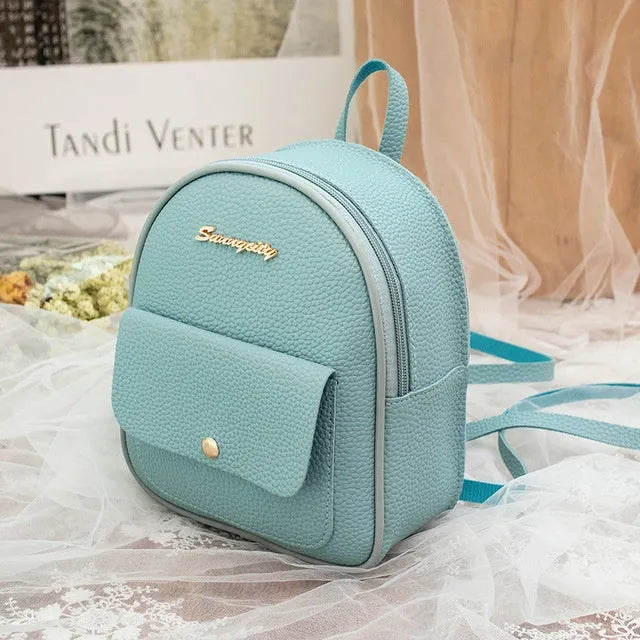 Women's compact black PU bag worn as both a shoulder bag and a small backpack.
