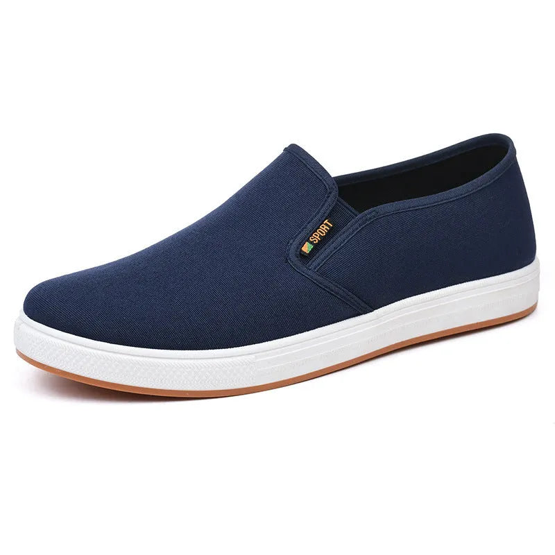 Men's black and blue slip-on canvas shoes with composite soles showing round toe design