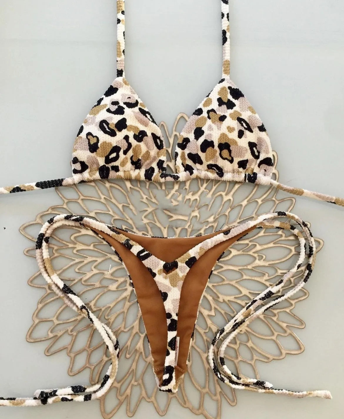 Women's printed bikini swimsuit with briefs style on a neutral background.