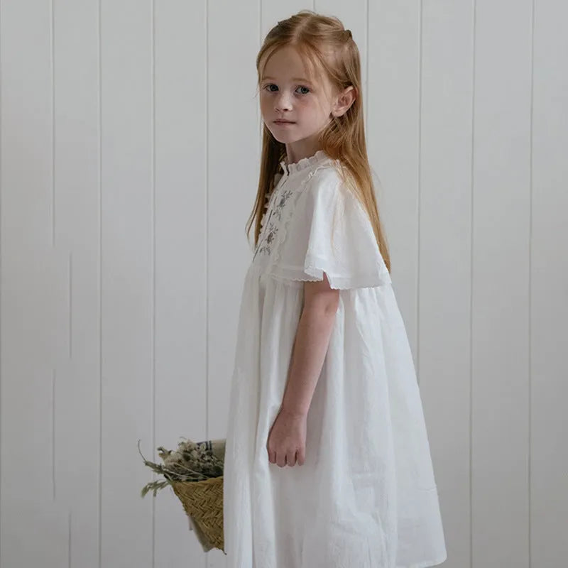 White washed cotton girls dress with short sleeves, ruffled and embroidered skirt for summer