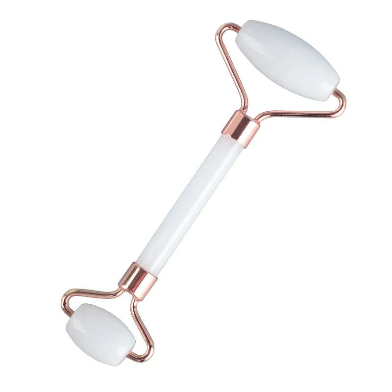 Natural white jade double-headed facial roller and gua sha scraping board set on a plain background.
