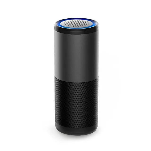 Black portable mini car air purifier with USB cable on a car dashboard
