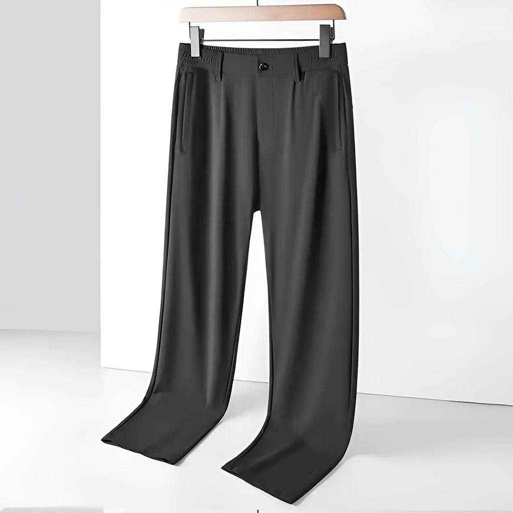 Man wearing black loose-fit ice silk straight leg casual trousers.