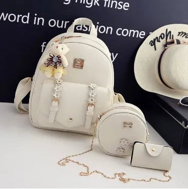 Women's 3-piece floral leather bag set showing backpack, shoulder bag, and card purse
