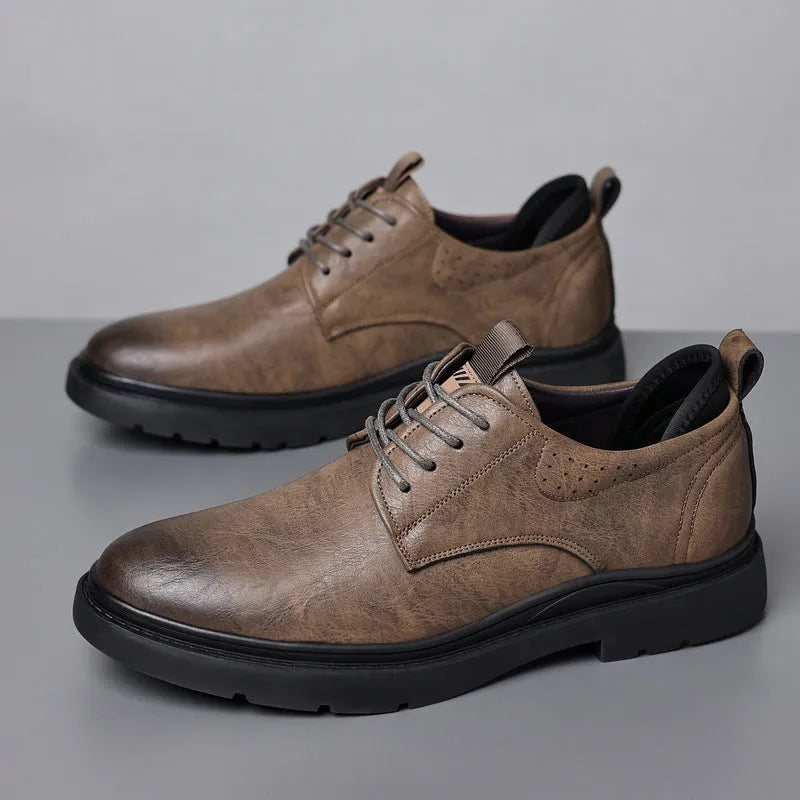 Men's black and brown leather sneakers with rubber sole and decorative sewing line detailing on cowhide upper