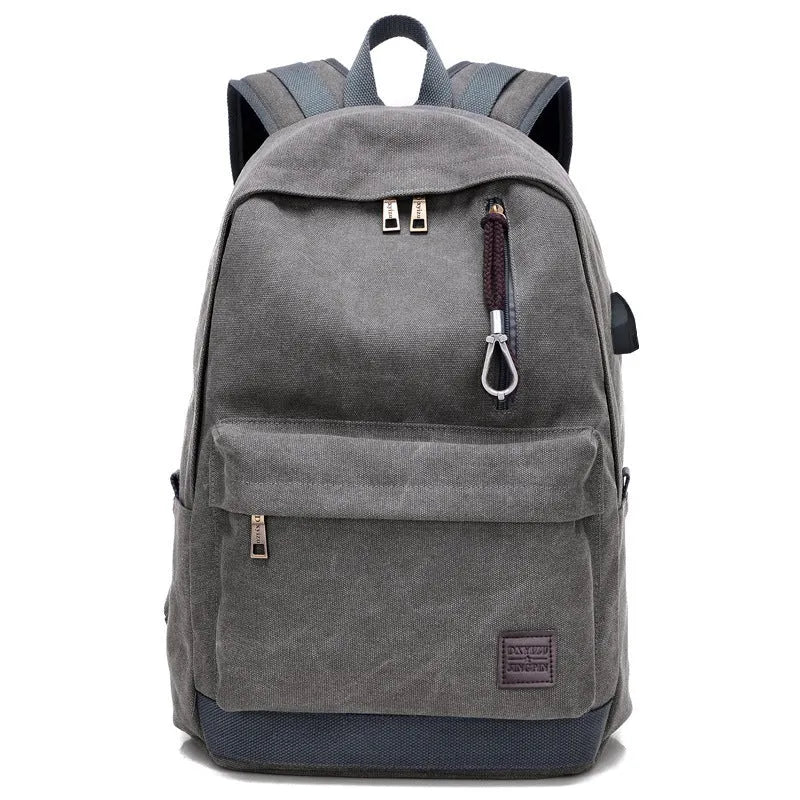 Canvas backpack with USB charging port showing laptop compartment and multiple pockets