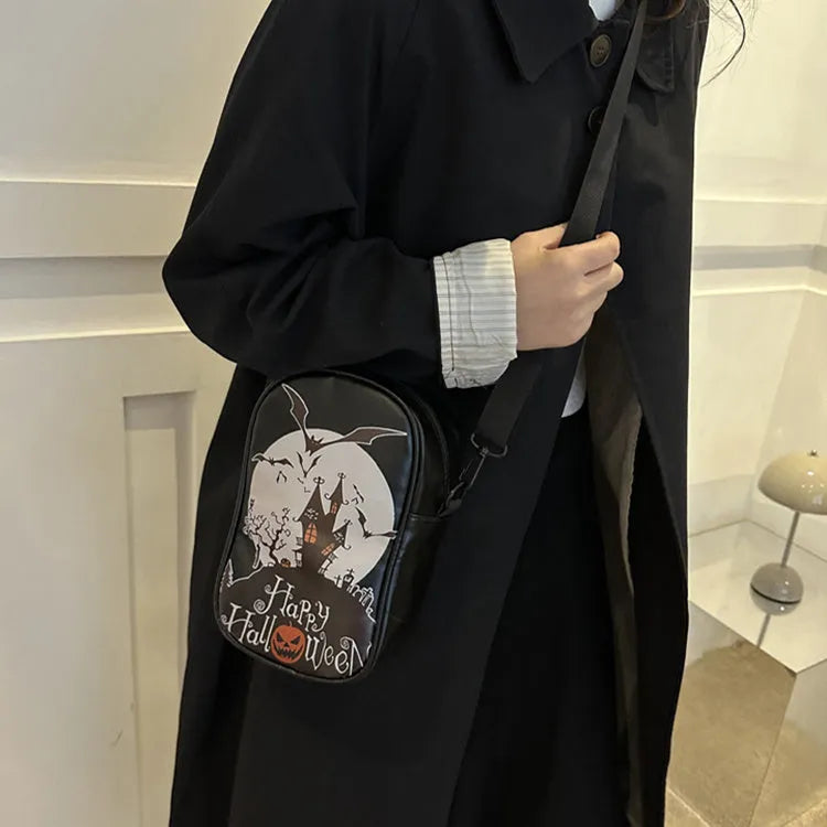 Black mini crossbody phone bag with Halloween graffiti print showing pumpkins, ghosts and bats