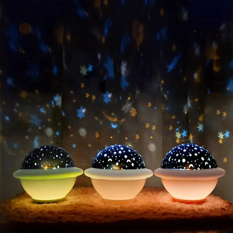 Pink UFO-shaped LED night light projecting a starry sky pattern on a wall.