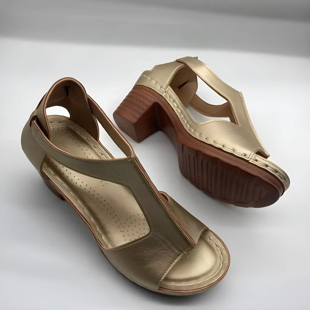 Women's peep toe wedge sandals with buckle detail, low heel, on a white background.