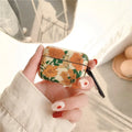 Light yellow hard plastic AirPods case cover with daisy design on white background
