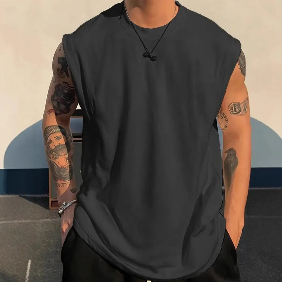 Men's loose-fitting solid colour cotton tank top on a hanger, shown in a light colour.