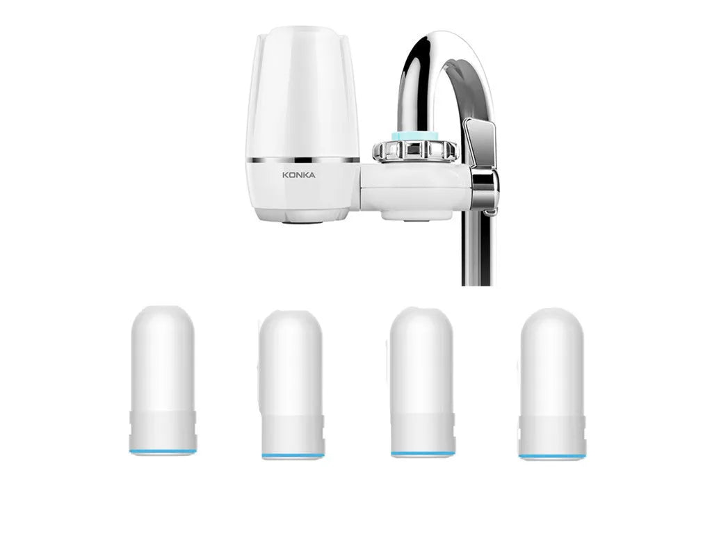 White plastic kitchen tap water filter with ceramic cartridge and universal adapter kit on a counter.