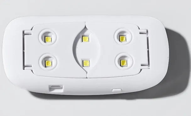 Mini Mouse pink LED phototherapy machine for nail gel curing with 6 lamp beads on a white surface