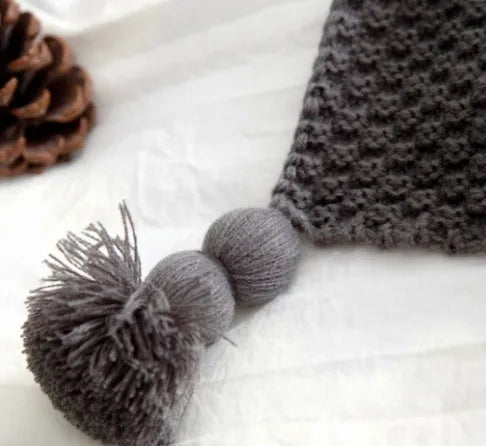 Nordic-style fringed knit acrylic blanket in a neutral colour, laid flat showing its 130x170cm size.