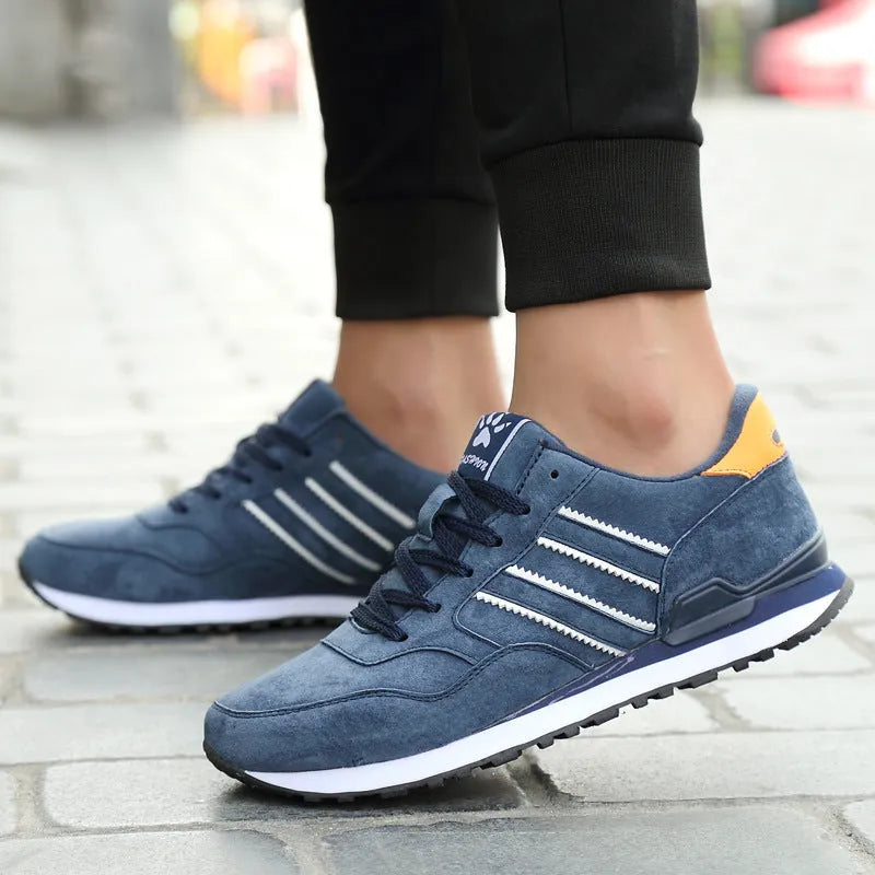 Blue leather sneakers for men with low-top design, pigskin upper, and rubber sole on a plain background