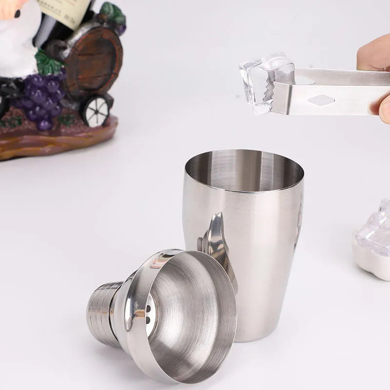 8pc stainless steel cocktail shaker set with graduated pieces on a table, various heights from 11cm to 18cm