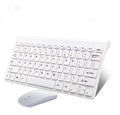 Black wireless keyboard and mouse set with USB receiver on wooden desk
