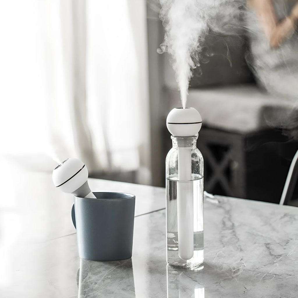 Pink and white columnar magic wand humidifier with USB cable and optional battery base