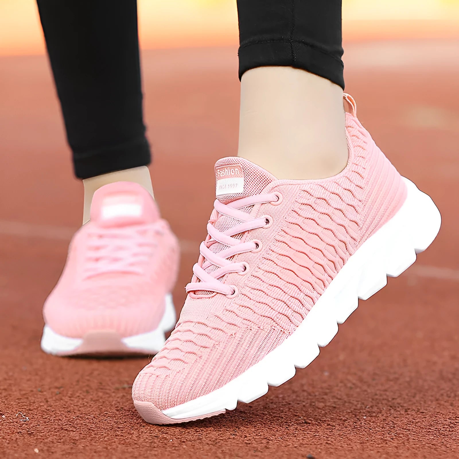 Women's black running shoe with fly weave upper and textured wear-resistant outsole.