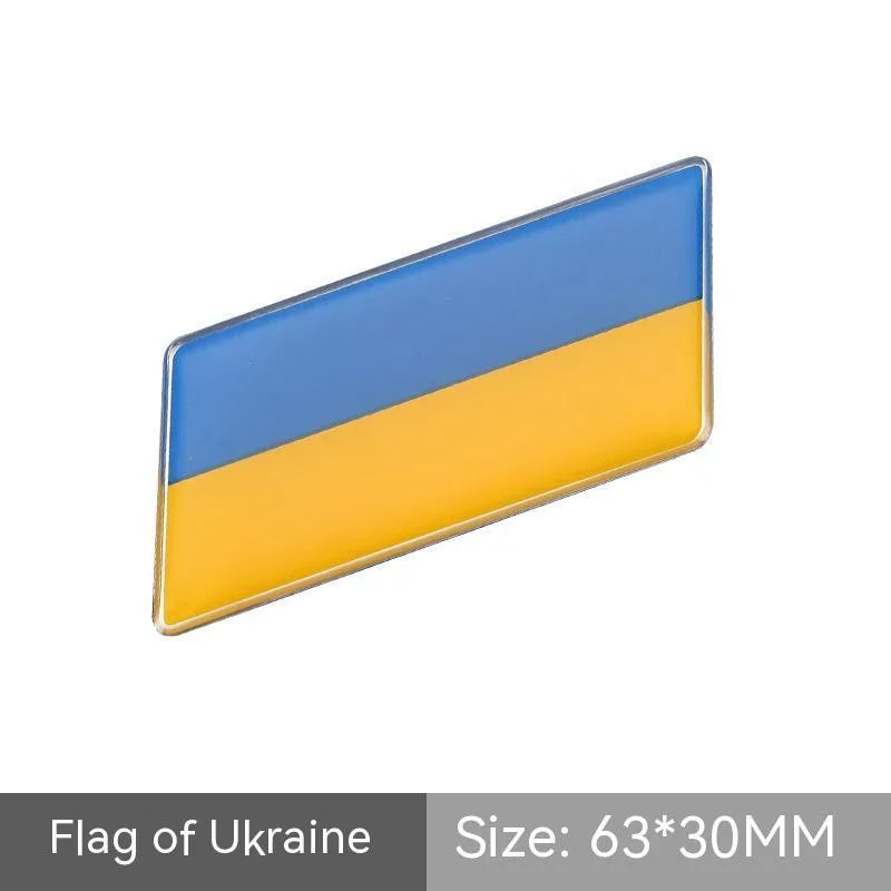 Aluminium parallelogram car sticker showing a national flag design, measuring 6.3 by 3 centimetres.