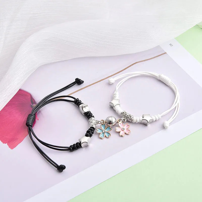 Magnetic clasp couple bracelets with alloy construction and symbolic designs including crown and love lock motifs.