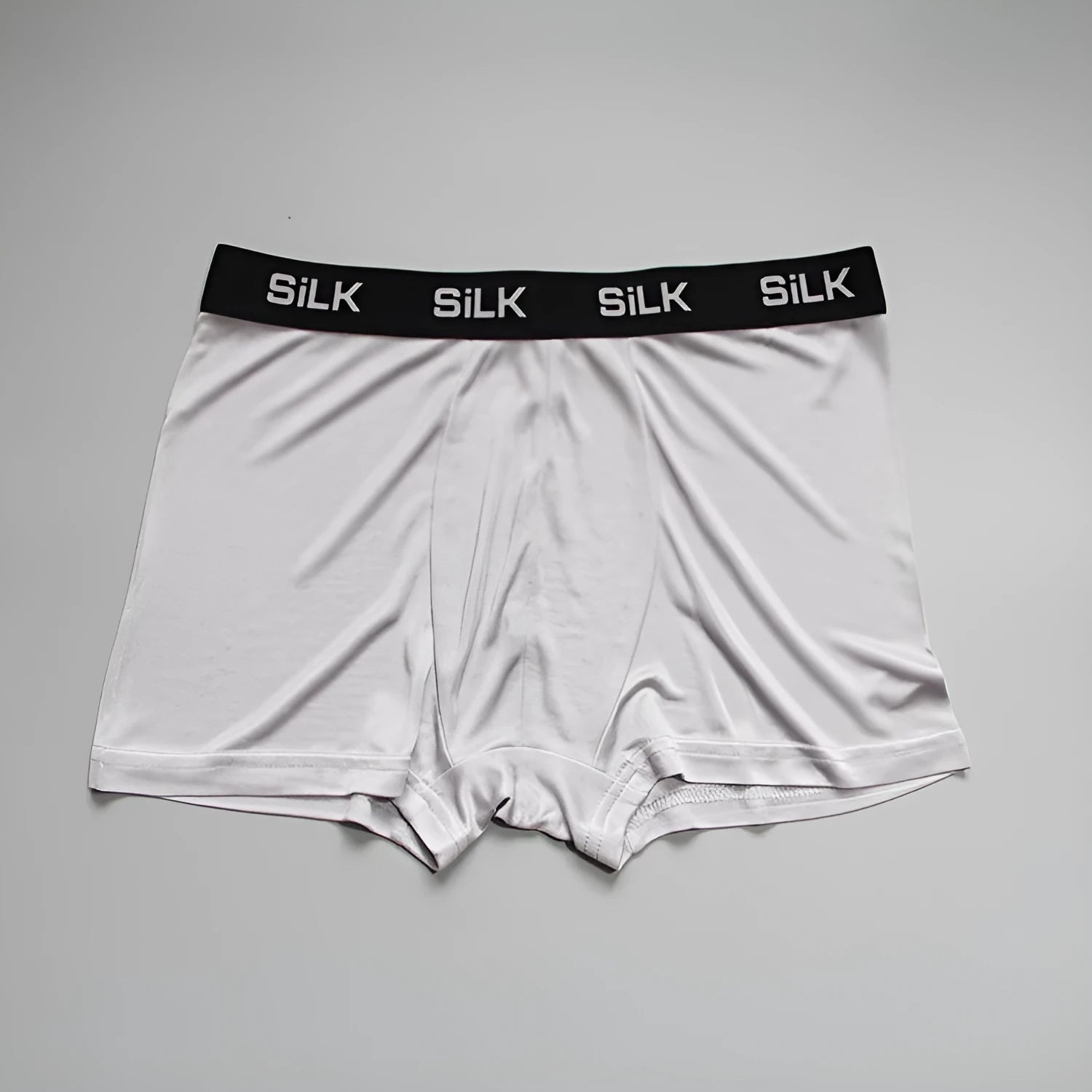 Men's loose-fitting silk shorts in navy blue on a mid-waist.