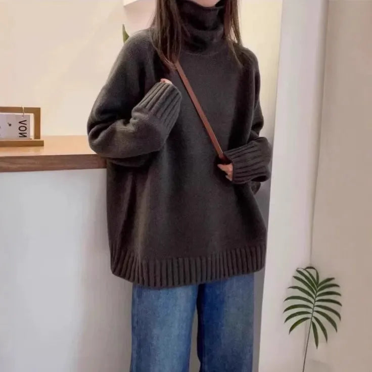 Women's loose grey turtleneck sweater with a thick, textured curling pile collar