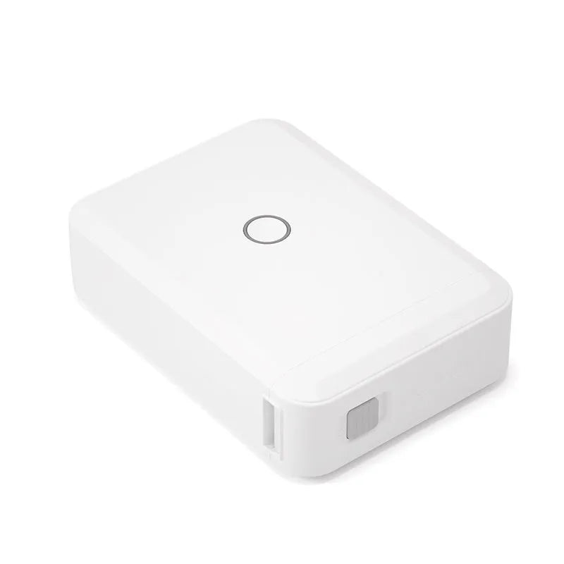 White D110 Bluetooth thermal label printer on desk with label tape showing 12mm print width