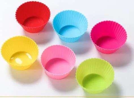 12 nonstick reusable silicone cupcake liners in six colours arranged for baking