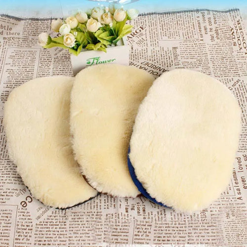 Pair of soft artificial wool car wash cleaning gloves in black, 15x24cm, on a car surface