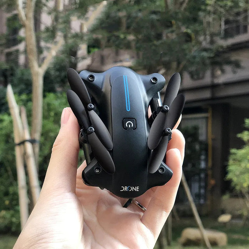 Mini folding drone with 4K camera in black, folded size 8x4x7cm, showing four rotors and remote controller