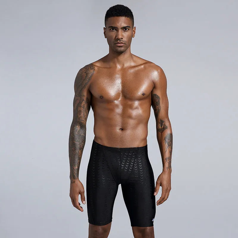 Men's solid colour waterproof shark skin fabric swimming trunks in pool setting
