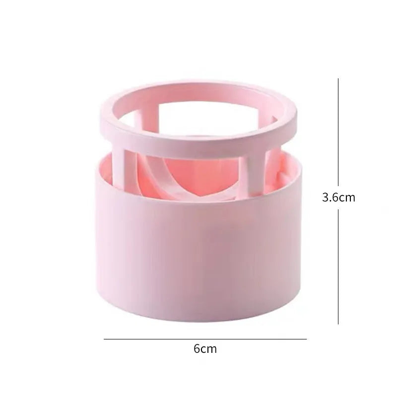 Pink plastic beauty egg stand cosmetics storage rack in girly heart style on a bedroom desktop