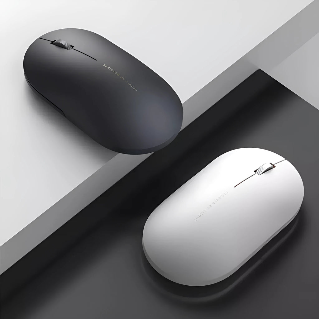 Ultra-thin grey wireless mouse with touch wheel and two buttons on plain background