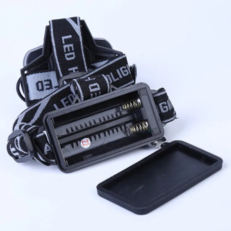 Fixed focus LED head torch with head strap, showing long-range beam for outdoor use.