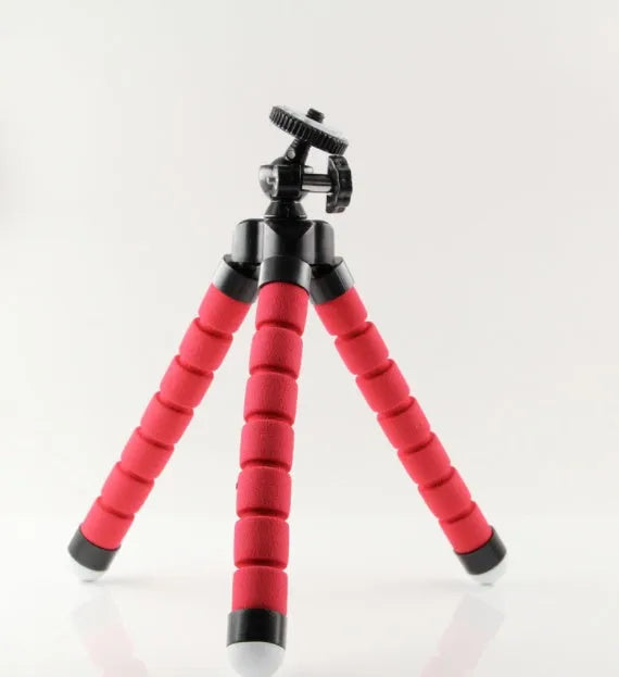 Black flexible octopus tripod with wrapped legs next to a smartphone, showing its 18cm size and universal screw mount.