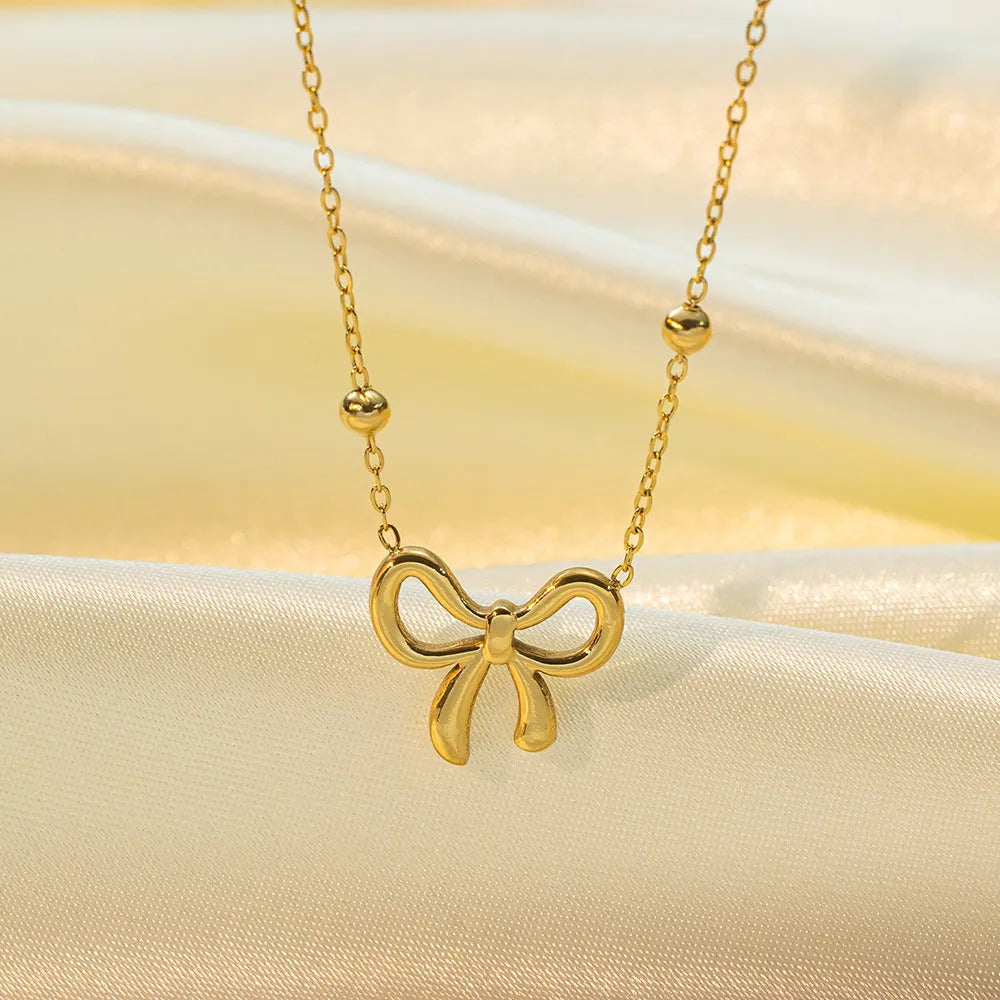 Gold titanium steel bow necklace with cross chain style for women