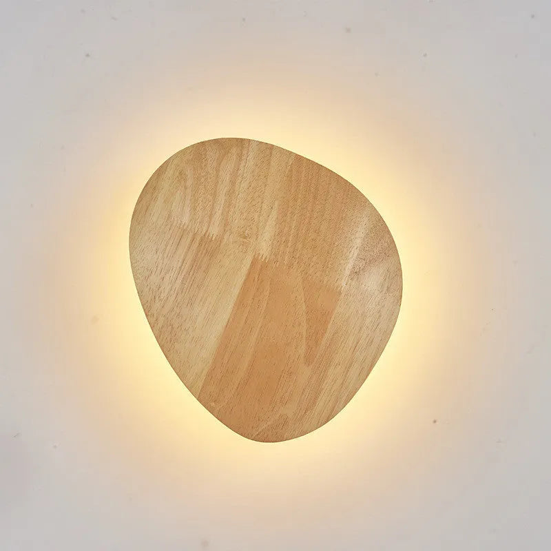 Log Art wood LED wall lamp with oval shape and warm light on a white wall