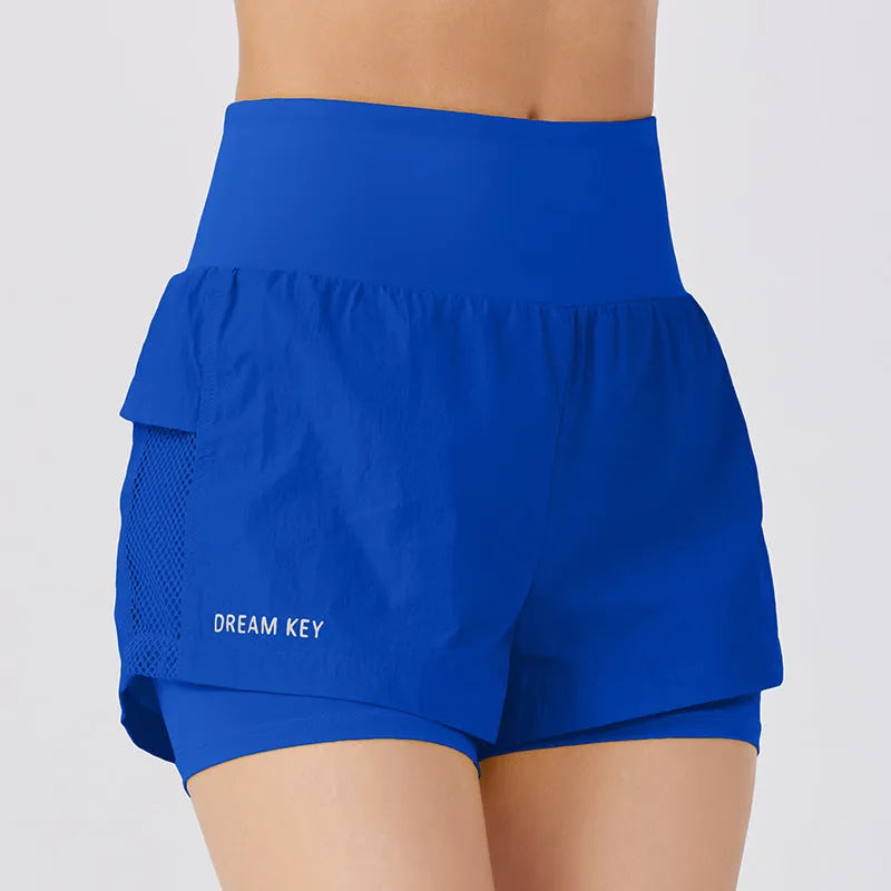 Women's loose fit cotton blend fitness shorts in lemon yellow colour on a hanger