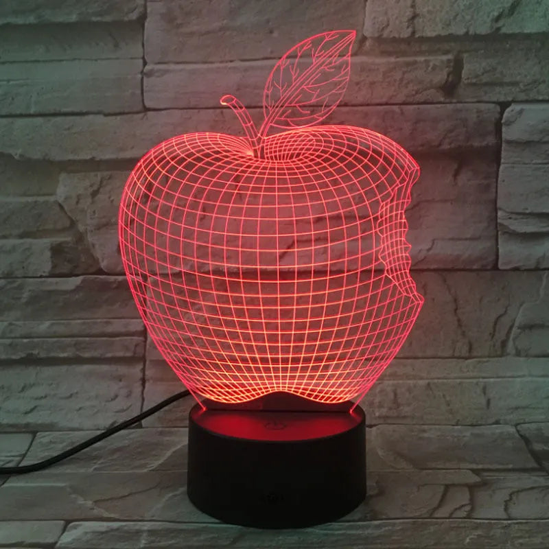 3D fruit-shaped colourful night light with acrylic shade and touch control on a dark surface