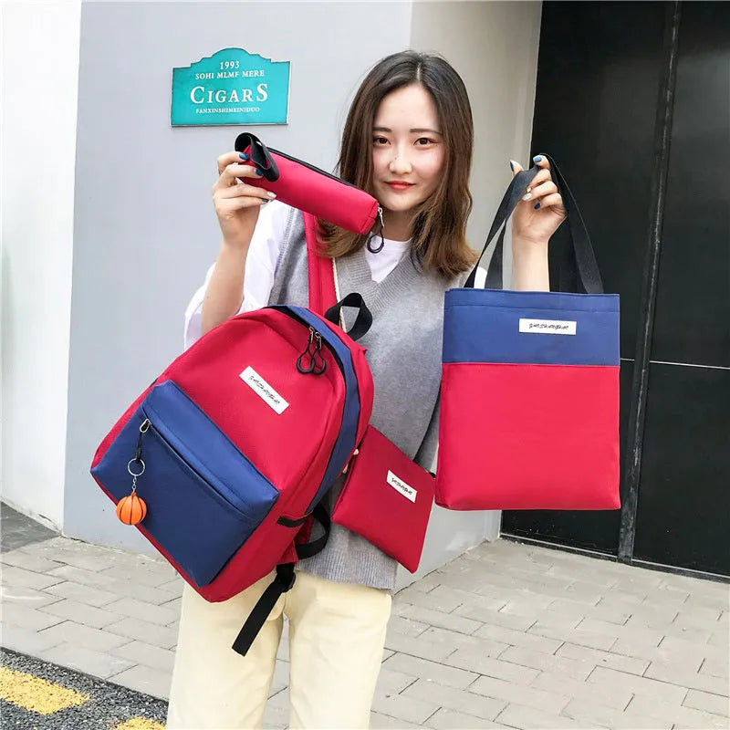 Four medium canvas backpacks in black, green, red, and white with zipper closure and air cushion straps