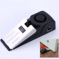 Black 120dB door stop alarm with stainless steel cover and wedge shape, measuring 14cm long
