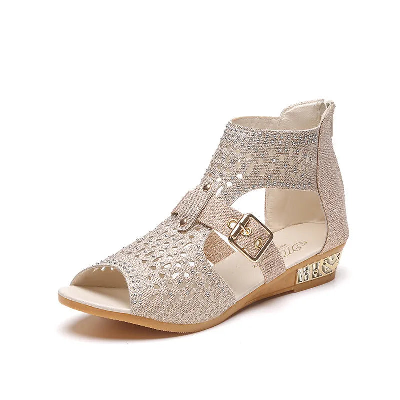 Women's beige rivet sandals with a back zipper and a low wedge heel.
