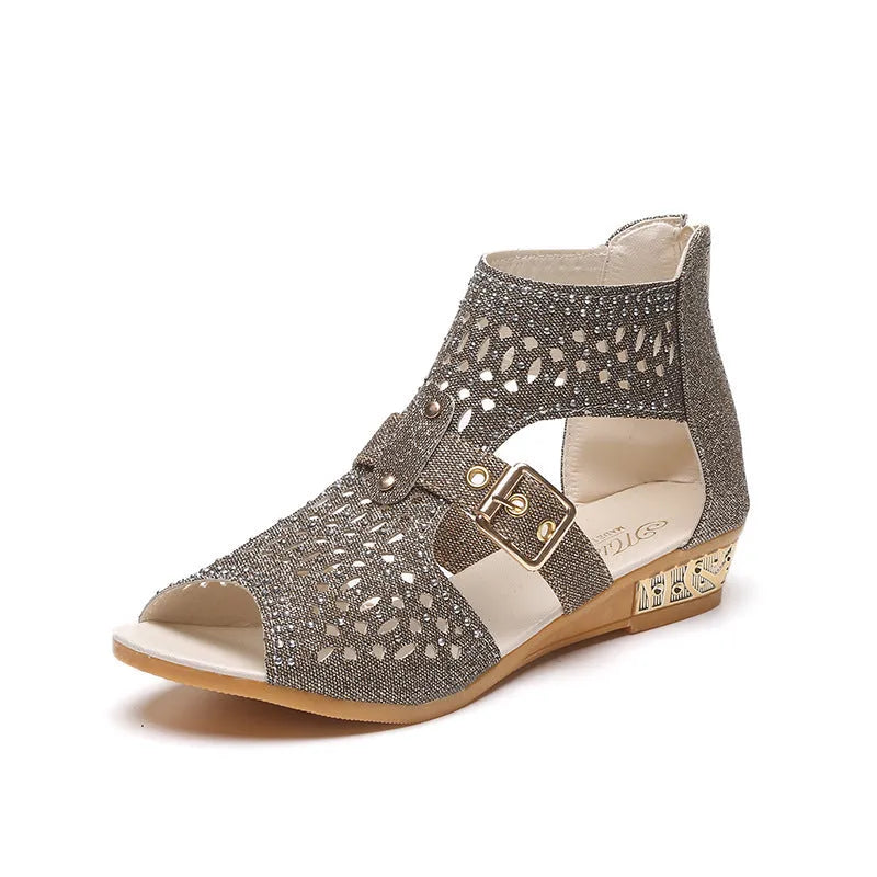 Women's beige rivet sandals with a back zipper and a low wedge heel.