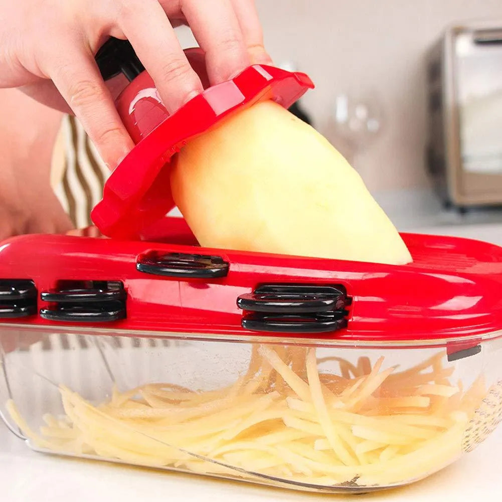 Red multifunctional vegetable cutter with seven stainless steel blades, capacity tub, and hand guard